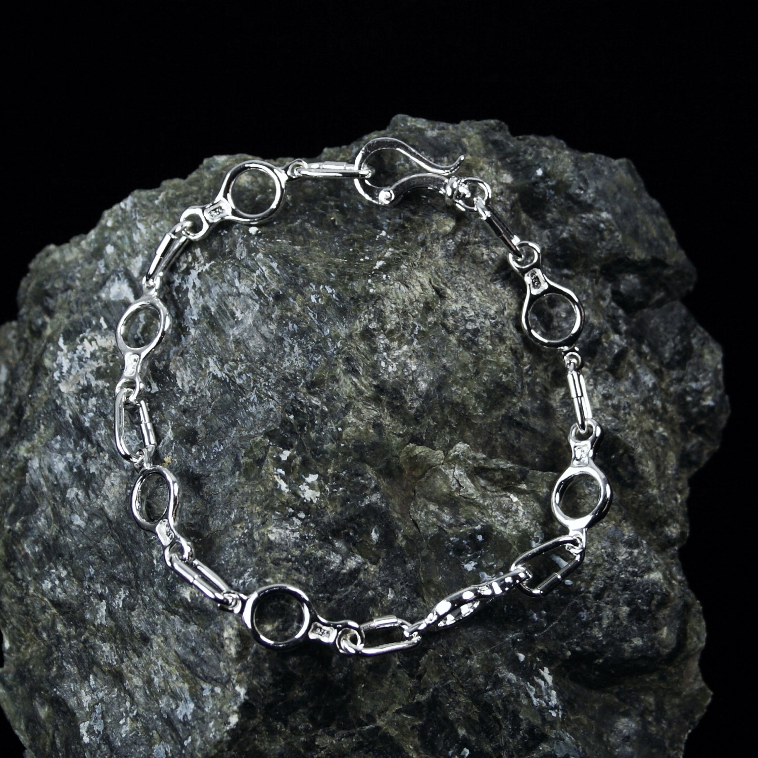 Figure 8 Descender Linked Bracelet - Handmade in sterling silver - Rock background